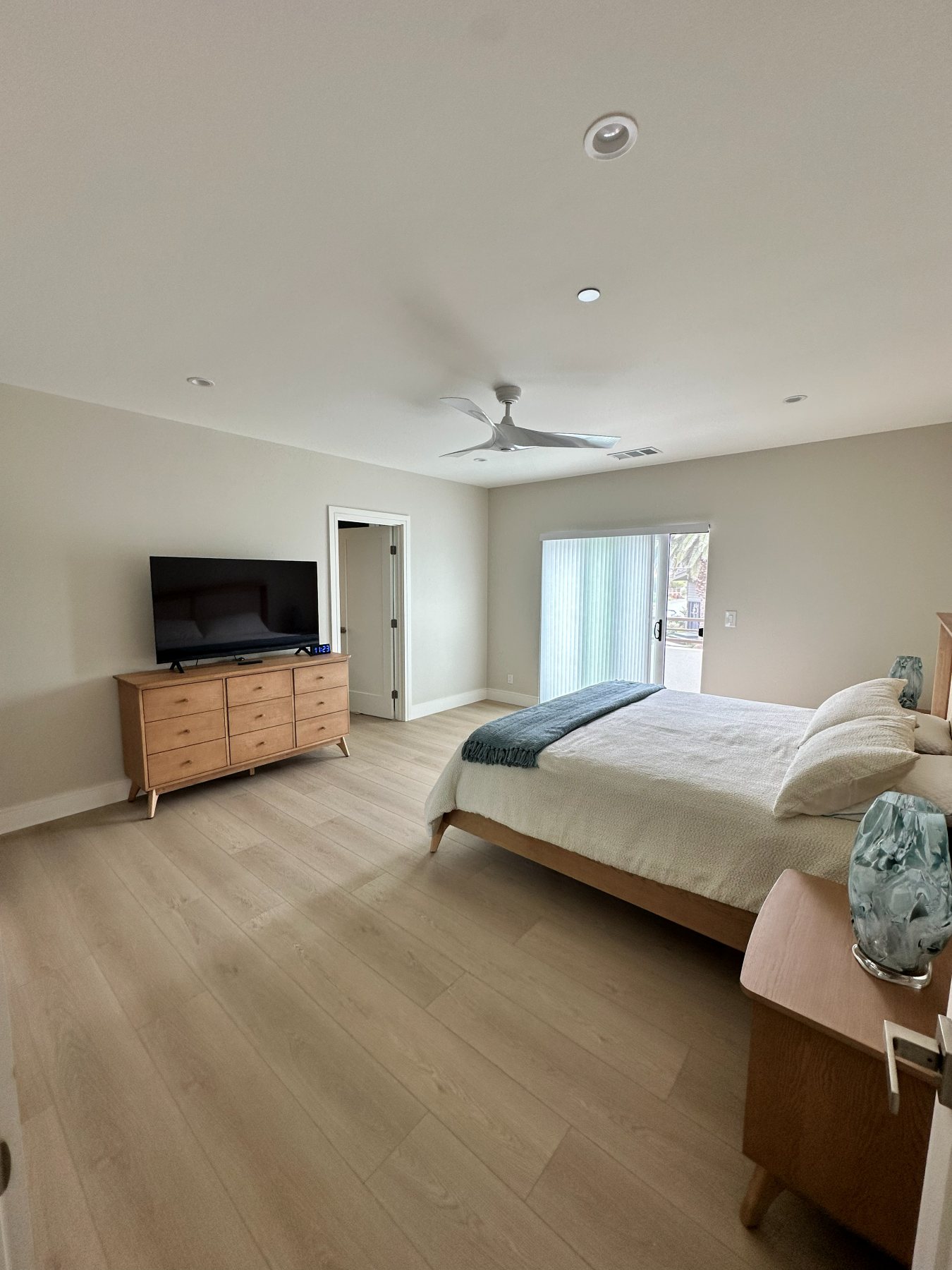 Primary bedroom with a sliding glass door to a private deck.