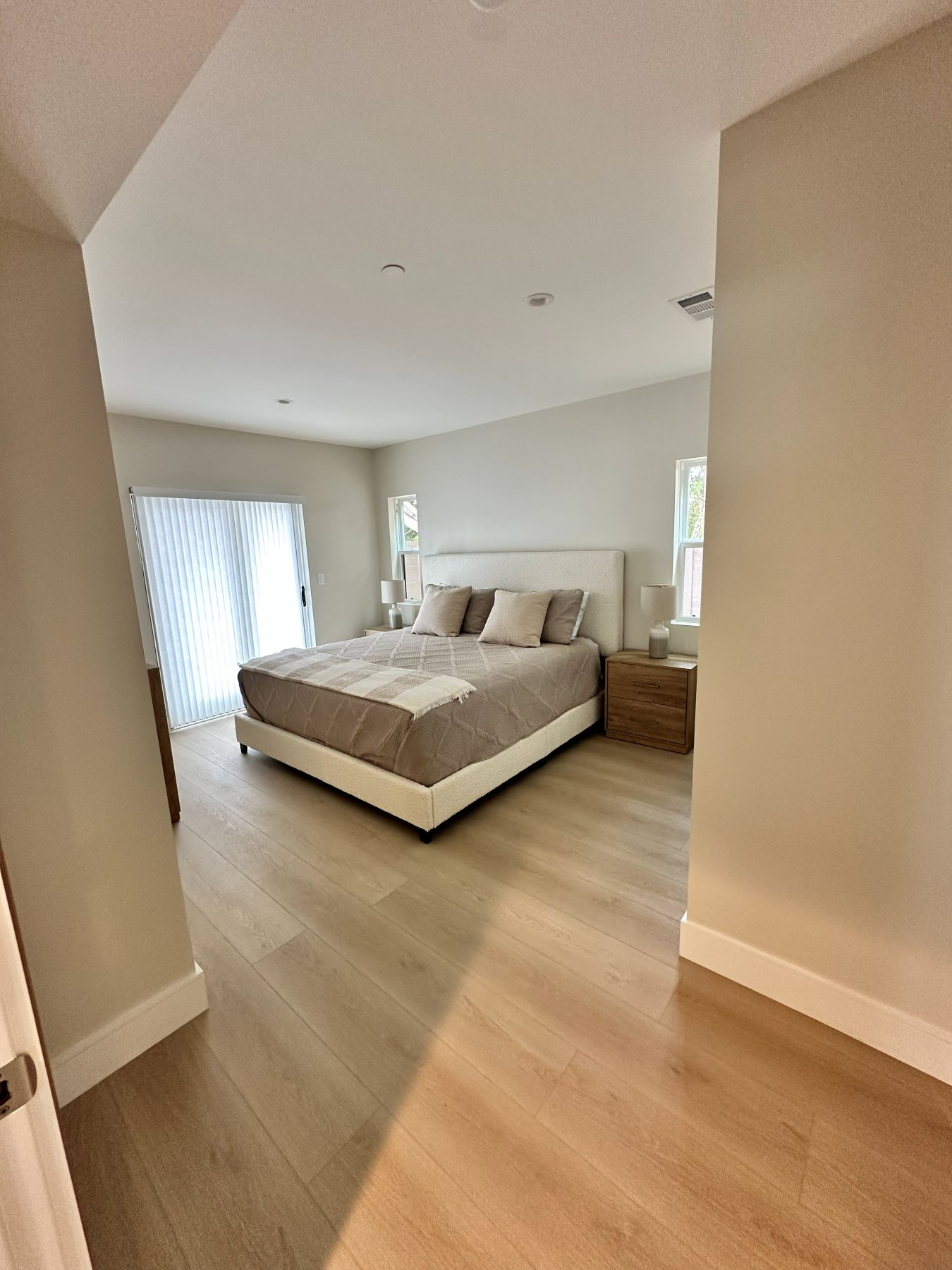 A bedroom with sliding closet doors and ensuite bath access.