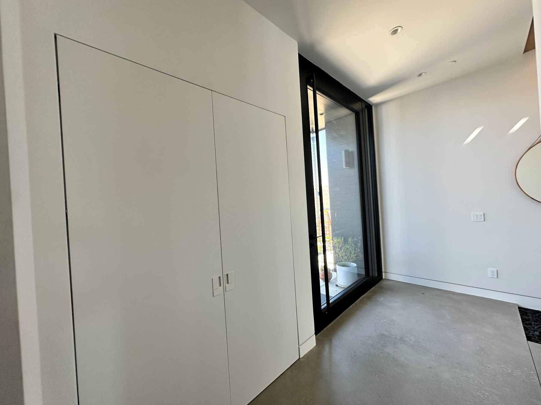 A bedroom with a sliding glass door to a private deck.