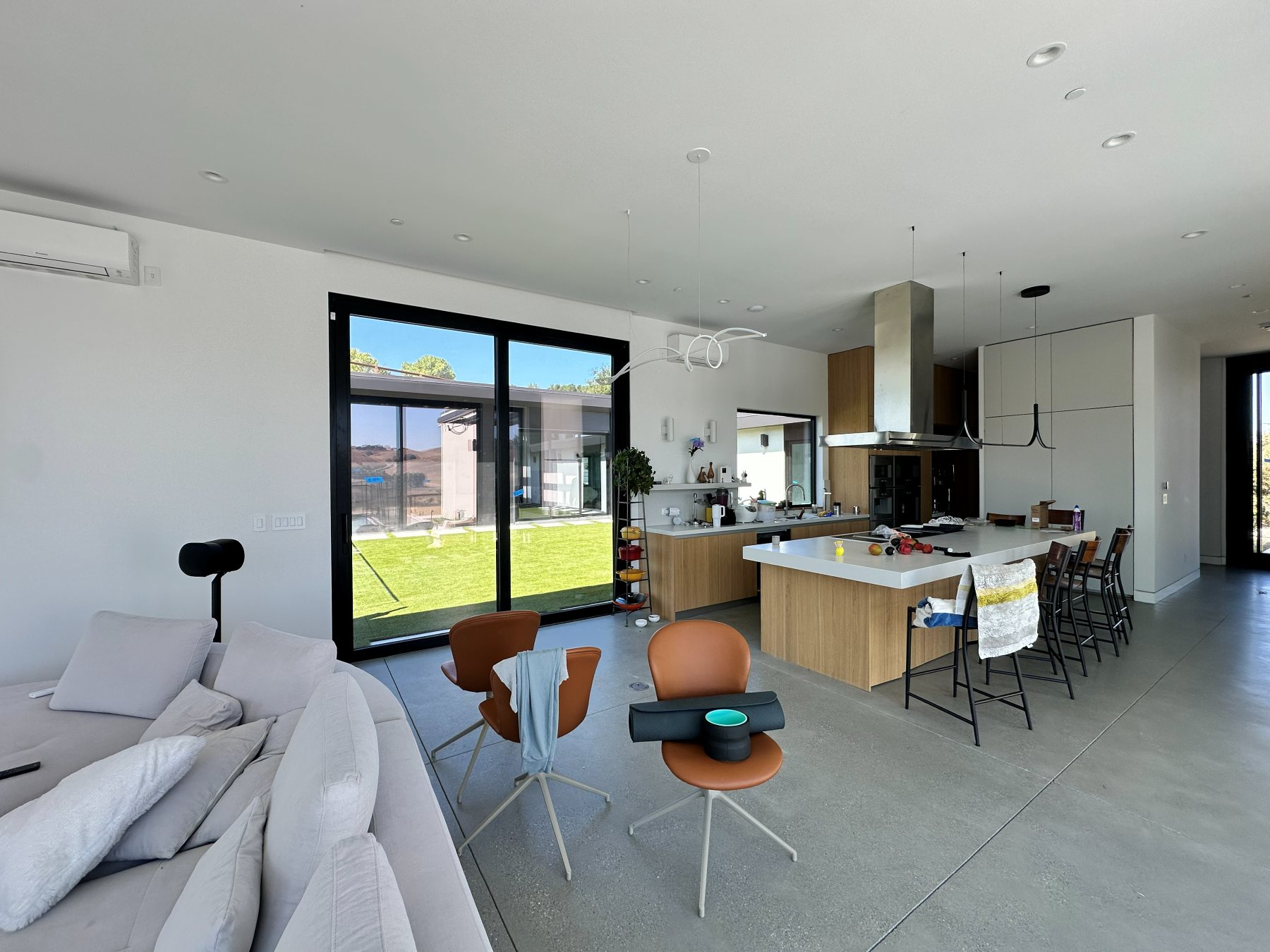 Open kitchen and living area, with a sliding glass door to the turf backyard.